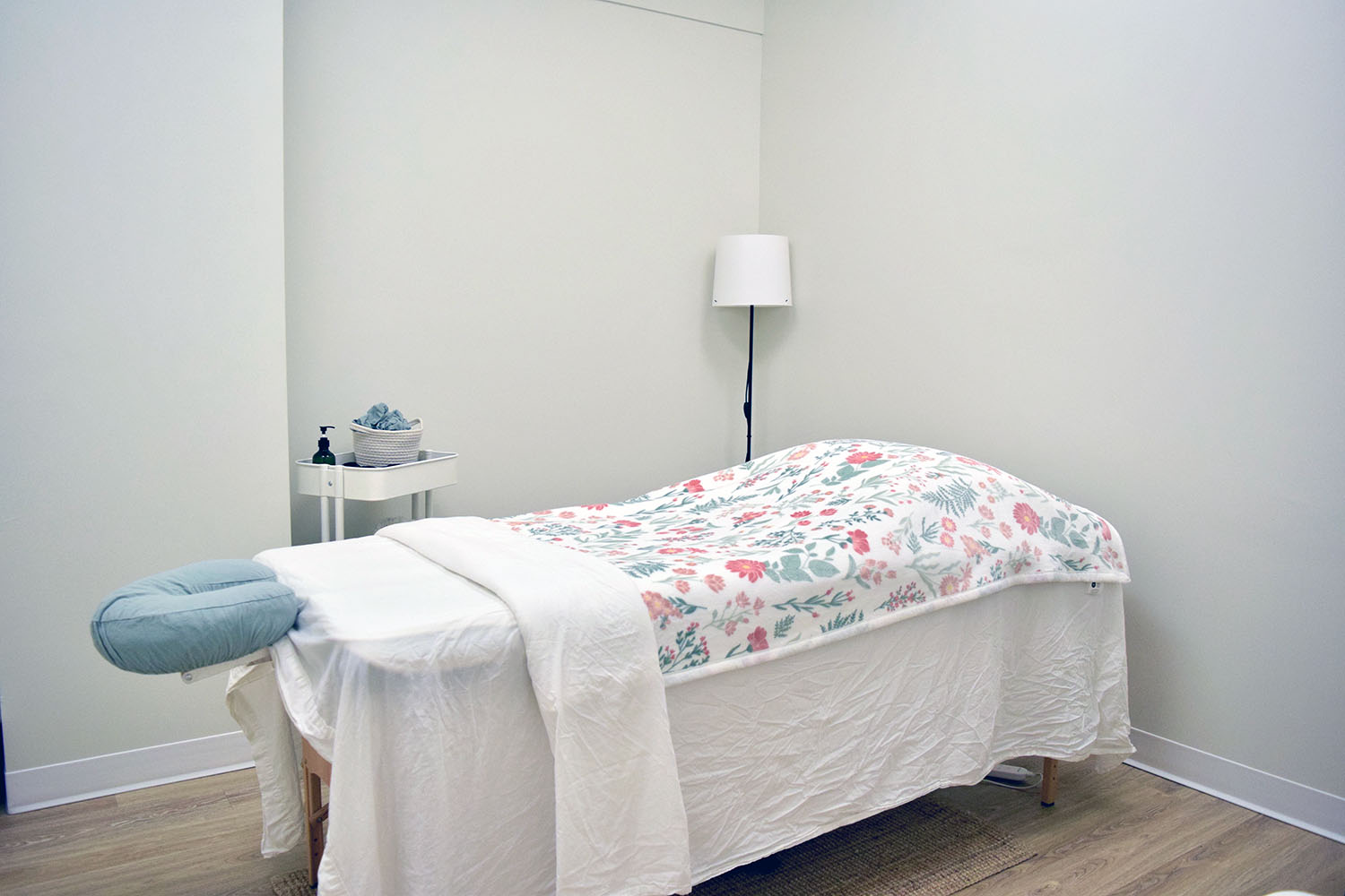 Massage therapy table with soft linens in a calm treatment room at Woodside Chiropractic, Dartmouth NS.